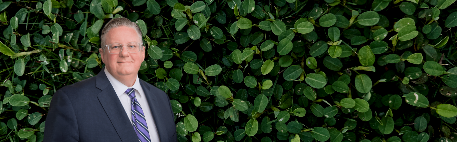 Dr. Michael Ott's image imposed over a field of greenery. Background photo by Kevin Huynh
